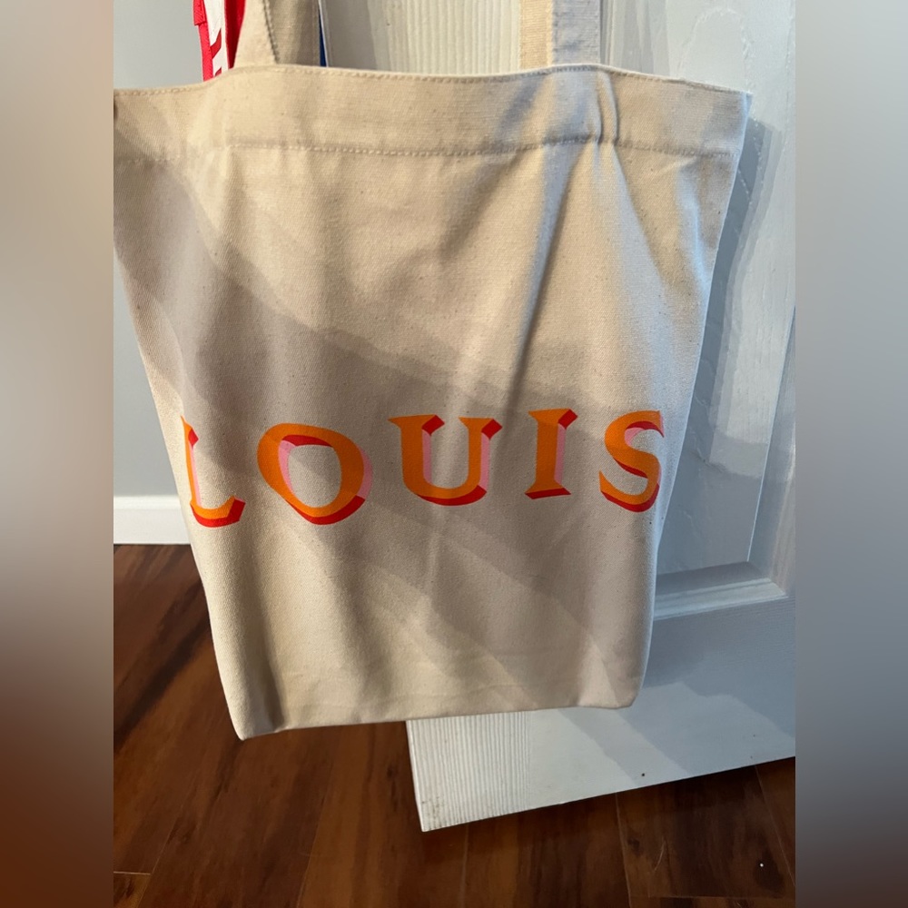 Louis Vuitton tote and books